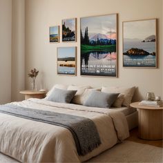 a bed sitting in a bedroom next to two pictures on the wall