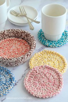 crocheted coasters and cups on a marble table