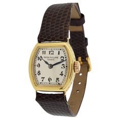 Patek Philippe 1928-1929 Early Cushion Ladies Watch; Made in 18K yellow gold measuring 21 x 21mm with a silvered dial, black Breguet numerals, Blue steel hands. The watch is fitted with an 8-85 caliber 18-jewel manual wind movement 815235 / 292644. The case is engraved on the side, and with its original onion crown. Further the watch is fitted with a brown lizard strap. Essay: This early ladies watch is quite rare because Patek did not manufacture a large quantity of small movement. This was manufactured while the last of the Patek family was still running the company. The Early design shape and easy to read dial makes this watch quite special. Wind Movement, Blue Steel, Ladies Watch, Patek Philippe, Vintage Watches, Womens Watches, Wrist Watch, Fashion Forward, Jewelry Watches