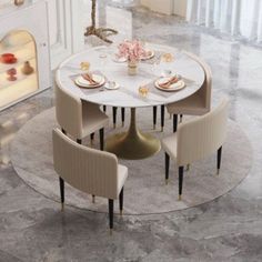 a dining table with four chairs around it