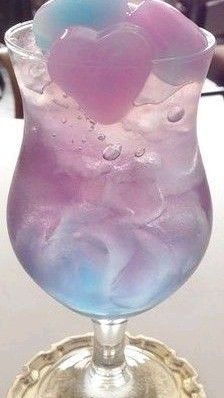 a purple and blue drink sitting on top of a table