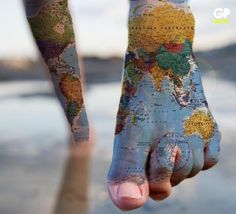 a person's hand with the world map painted on it