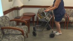 a woman pushing a shopping cart in a living room