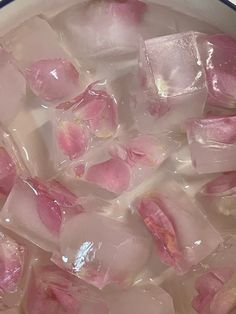 ice cubes with pink flowers are in a pot on the stove top, ready to be cooked