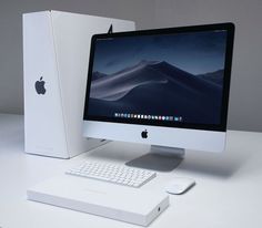 an apple desktop computer sitting on top of a white desk