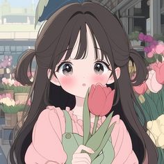 a girl holding a flower in front of her face