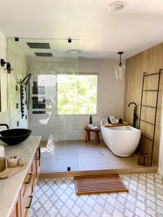 a bathroom with a large bathtub next to a walk in shower