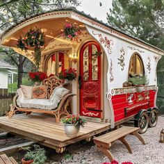 a red and white carriage with flowers on it