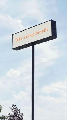 there is a sign that says take a deep breath on the side of a pole