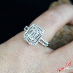 a woman's hand with a diamond ring on it