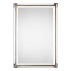 a large silver framed mirror on a white wall