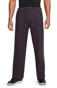 Taping-style side stripes in a softly contrasting hue bring understated branding to these straight-leg pants you'll reach for every weekend. 32 1/2" inseam; 22" leg opening; 12 1/2" front rise; 17 1/2" back rise (size Medium) Elastic/drawstring waist Side-seam pockets; back welt pockets 94% polyester, 6% elastane Machine wash, dry flat Imported Nordstrom x Nike: A curated lifestyle destination where fashion is the ultimate sport Air Jordan Pants, Jordan Air, Side Stripe, Drawstring Pants, Welt Pockets, Straight Leg Pants, Drawstring Waist, Leg Pants, Air Jordan