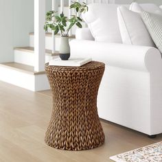 a living room with a couch, coffee table and rug on the floor in front of it