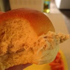 a half eaten donut with peanut butter on it sitting on a yellow and white plate