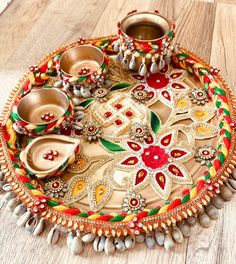 a decorative tray with various items sitting on top of wooden floor next to each other