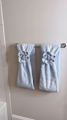 two blue towels hanging on a towel rack