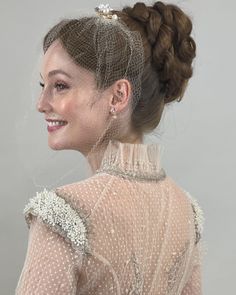 a woman in a white dress with a veil on her head