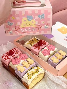 two pieces of cake in a pink box