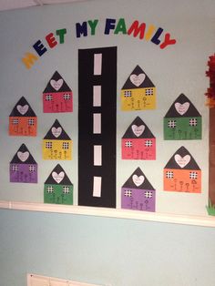 a child's room wall decorated with houses, numbers and the words meet my family