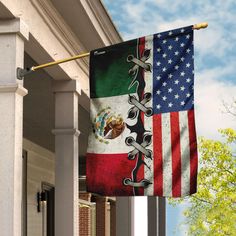 an american and mexican flag hanging from the side of a building