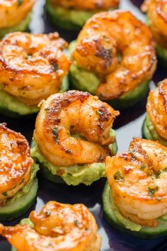 shrimp and avocado stuffed cucumbers on a baking sheet ready to be served