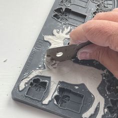 someone is using a pair of pliers to cut out the snowflakes on their ice trays