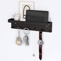 a wall mounted shelf with keys, watch and wallet