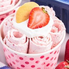 some strawberries are in a pink polka dot cupcake liners and there is a strawberry on top