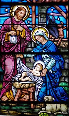 a stained glass window depicting the birth of jesus