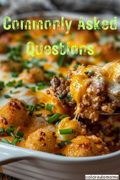 a casserole dish filled with cheese and ground beef, topped with green onions