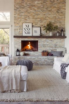 a living room filled with furniture and a fire place in the middle of it's wall