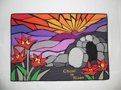 a stained glass piece with the words christ is risen in front of mountains and flowers