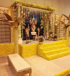 the stage is decorated with yellow flowers and decorations