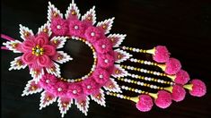 a pink and white wreath with flowers on it