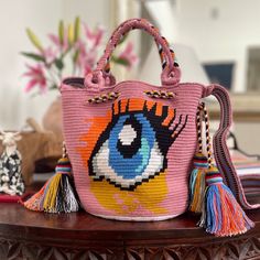 Pink, Large size Wayuu eye, Crossbody and shoulder strap and short braided handle. Crochet Purse, Christmas gift, Bohemian style by CostaWayuu on Etsy Eye Meaning, Pattern Bag, Wayuu Bag, Eye Pattern, Crochet Purse, Luck Charm, Blue Eye, Crochet Purses, Acrylic Material