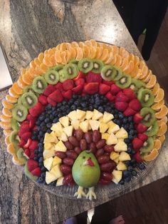 a platter filled with fruits and vegetables on top of a table