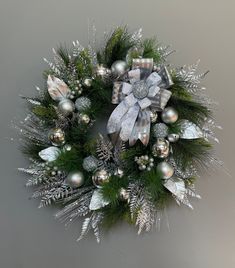 a christmas wreath with silver and silver ornaments