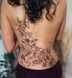 the back of a woman's body with flowers on it