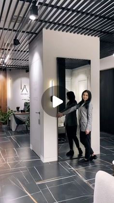 two women are standing in an office lobby