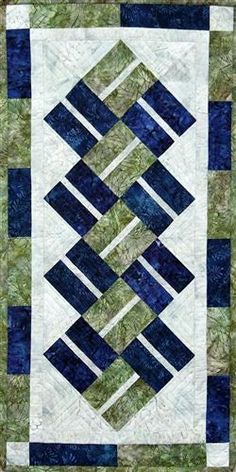 a blue and green quilted wall hanging