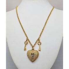 1980s goldtone pave round clear rhinestone heart with lock cut out center pendant with two goldtone key charms on either side necklace with lobster clasp. Marked "Napier" in script on a cartouche near the clasp and "©Napier" in script on the back of the pendant. Heart pendant measures: 1 1/8 inches long by 1 inch wide. Chain doubled measures: 15 1/4 inches long. Condition: Very good; perhaps a little bit of yellowing to a few rhinestones but nothing very noticeable. Gold Heart Necklace With Two Keys, Key Charms, Lock Pendant, Pendant Heart, Heart Lock, Rhinestone Heart, Clear Rhinestones, Vintage Signs, Heart Pendant