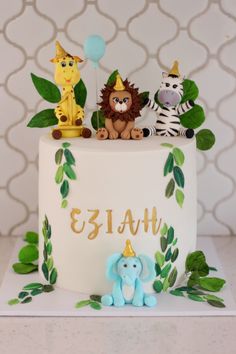 a birthday cake decorated with animals and balloons