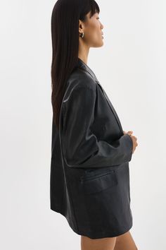 Indulge in the timeless elegance of the QUIRINA Leather Blazer, a quintessential addition to every discerning wardrobe. Crafted with a peaked lapel design and adorned with classic flap pockets, this blazer exudes sophistication and versatility. Its unlined construction ensures a feather-light feel, ideal for navigating transitional seasons with ease. Pair it effortlessly with jeans and a tee for an understated yet chic ensemble, or channel refined professionalism with the YAREN Leather Pants and Luxury Structured Blazer For Formal Occasions, Structured Formal Blazer, Formal Structured Blazer, Sleek Structured Blazer For Formal Occasions, Sleek Structured Formal Blazer, Classic Structured Formal Blazer, Luxury Fall Blazer For Formal Occasions, Luxury Formal Blazer For Fall, Timeless Formal Outerwear With Pressed Crease