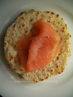 a piece of salmon on top of a tortilla