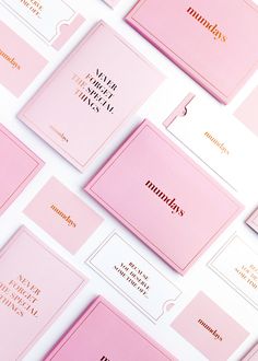 pink business cards with gold lettering on them