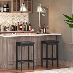 two stools in front of a bar with bottles on the counter and lights above it