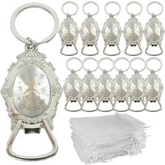 a bunch of silver metal items with white napkins on top of them and a bottle opener in the middle