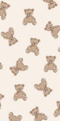 a group of teddy bears sitting next to each other on a white surface with black dots