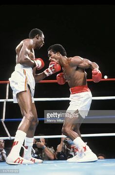 two professional boxers in the ring during a boxing match