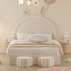 a white bed sitting in a bedroom on top of a hard wood floor next to a pink rug